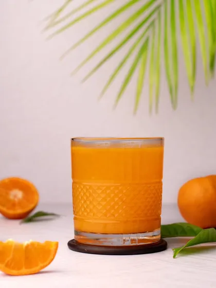 A bright and airy shot of a glass of fresh orange juice. This style is perfect for brands that want to convey a feeling of freshness and health.