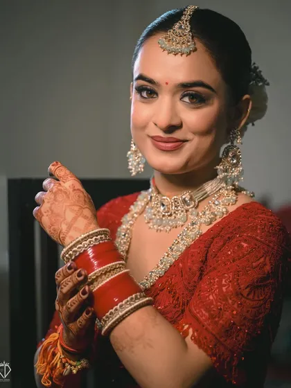A getting-ready shot where the bride is looking at her bangles. These moments of final preparation are filled with anticipation and make for beautiful, story-driven portraits.