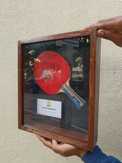 A look at the TT paddle shadow box from the side, showing the depth of the wooden frame and the glass front that protects the special memento inside.