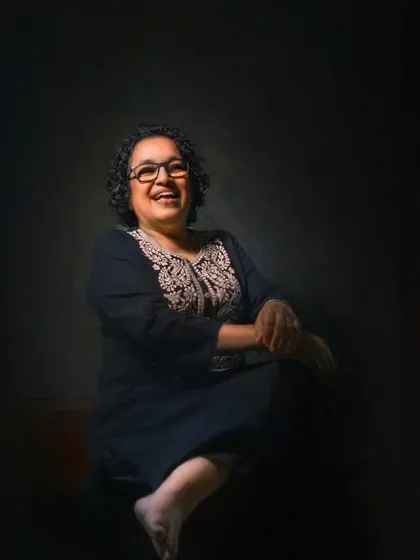 Laughter is a beautiful expression of the soul. This portrait captures a moment of pure, uninhibited joy, with the lighting focused on her happy face, creating an intimate and heartwarming image.