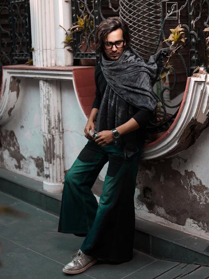 A similar pose with a focus on adjusting the glasses, adding a candid, intellectual touch to the winter street style look.