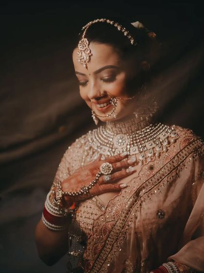A joyful close-up of the bride, her hand to her heart, capturing a moment of overwhelming happiness and gratitude.