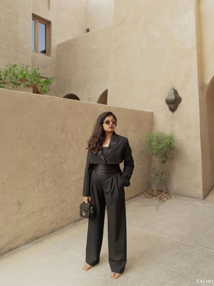 A confident and stylish solo portrait of the bride-to-be, showcasing her personality and fashion sense during the Dubai pre-wedding shoot.