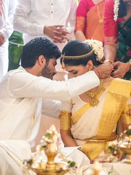 The tying of the 'thali' or 'mangalsutra' in a South Indian wedding, a deeply significant ritual.