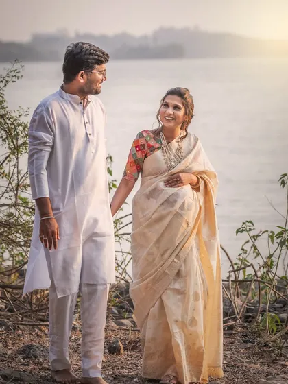 A beautiful, happy moment between the couple during their riverside shoot. Her joyful expression as she looks at him tells a story of love and shared excitement.