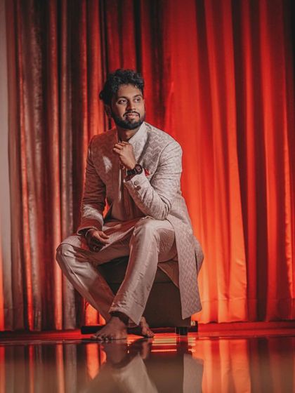 An artistic shot of the groom, titled 'Illuminati', using creative lighting for a high-fashion look.