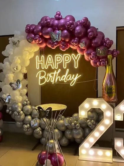 I love this modern and stylish color combination. For this 23rd birthday, I used a mix of purple, silver, and white balloons on a ring arch, accented with butterfly details, a champagne bottle foil balloon, and marquee numbers.