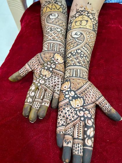 A beautiful engagement design with lotus flowers on the palms and interlocking rings on the forearms.