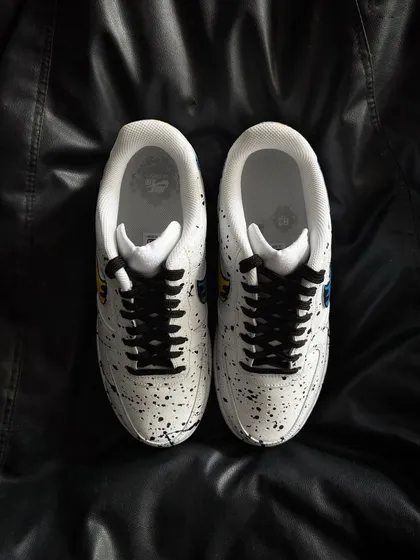 A top-down view of the dual-color drip custom sneakers.