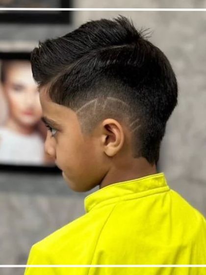 A side profile of the young boy's haircut, showing off the intricate line work and the clean fade.