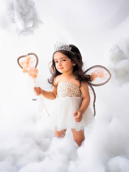 A confident pose from this little angel, ready to take flight.