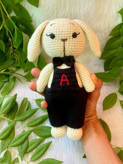 A dapper boy bunny! This little buck looks so smart in his black overalls with a personalized initial and a matching bow tie.