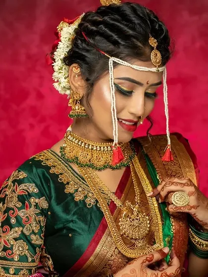 Another angle of this gorgeous Maharashtrian bride, showcasing the complete look with her hair, makeup, and jewellery. Our students learn to create a cohesive and balanced bridal style.