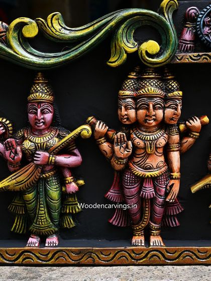 This detail from the Meenakshi panel highlights the four-headed Lord Brahma and Goddess Saraswati, rendered in vibrant, contrasting colors.