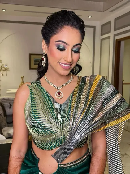 Glitz and glam for this cocktail night. This super glam and modern look features bold, shimmery green eyes that match her unique outfit perfectly.