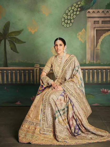 A full-length view of the regal Abu Jani Sandeep Khosla lehenga, showcasing its magnificent drape and intricate design against a beautiful backdrop.