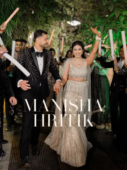The couple makes a grand entrance to their Sangeet, surrounded by friends holding light sticks. The energy is electric and full of celebration.