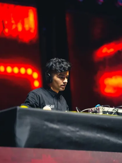 Higher grounds. A focused shot of me on a large stage, concentrating on delivering a perfect set.