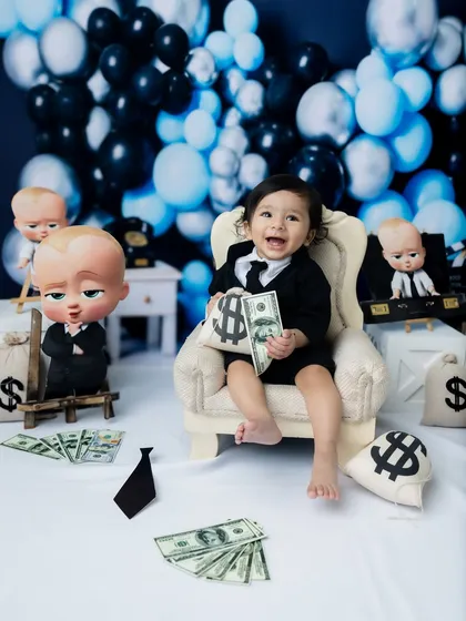 So happy with his earnings! The money props add a fun, playful element to the "Boss Baby" theme.