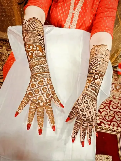 A full view of the back-hand bridal design, showing the intricate patterns extending up the arm.