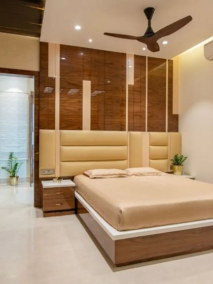 A sophisticated bedroom design with a leather-paneled headboard and high-gloss wood veneer, creating a sleek and luxurious feel.