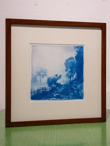 The framed version of the misty path cyanotype, showing how a quality frame enhances the artwork and prepares it for display.