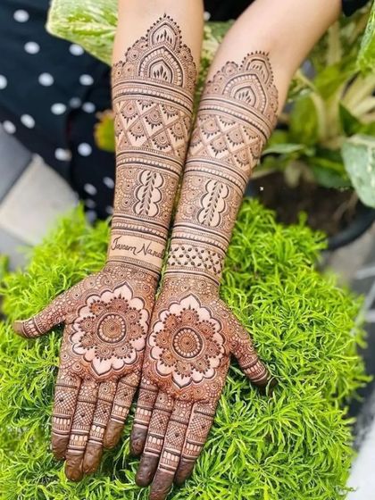 A beautiful mandala design with the couple's names written in the armbands. A lovely personal touch for a bride.