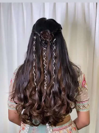 A beautiful, romantic hairstyle for an engagement. I created a half-updo with a small rose made of hair and added delicate, crisscrossing braids for detail.