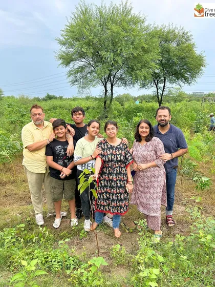 A family poses together after planting a tree in Noida. These drives are a wonderful way for families to bond while doing something meaningful for the environment.