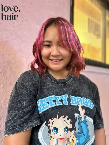 The client looking cute with her new pink and red hair, perfectly complementing her Betty Boop shirt.