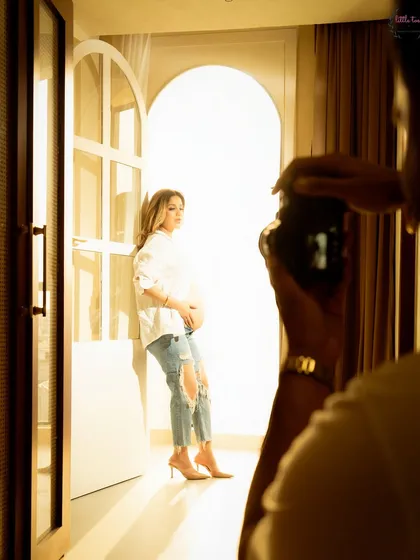A peek of me in action, capturing a beautiful, sun-drenched portrait during an in-home session.