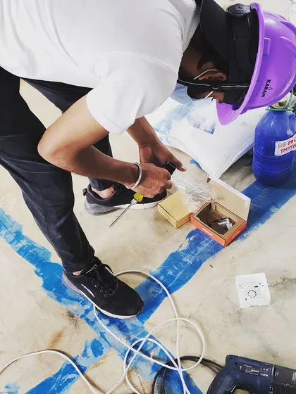 Attention to detail is crucial. Here, a member of our team is carefully preparing the smaller electronic components and connectors before they are integrated into the main access control panel.