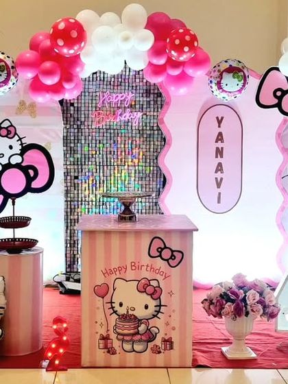 A sweet Hello Kitty themed 4th birthday party, featuring multiple character cutouts, a pink and white color scheme, and a shimmer backdrop panel.