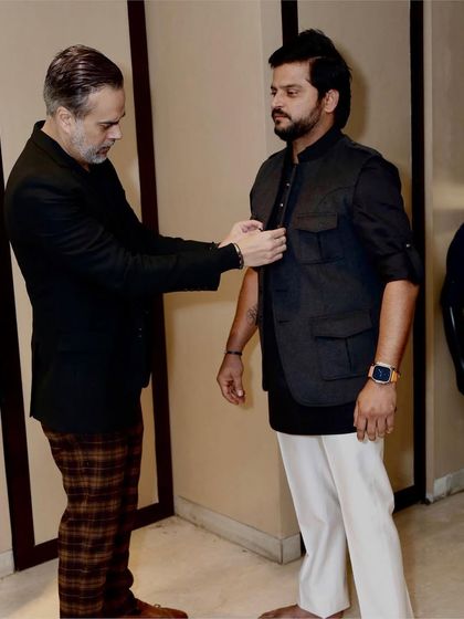 The fitting is a crucial step. Here, I am making sure the vest is a perfect fit for Suresh Raina, ensuring it's not just stylish but also comfortable.