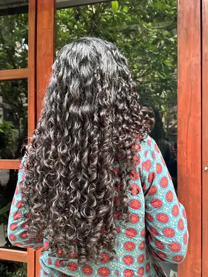 Embracing your greys doesn't mean you can't have fun with them. Here, I've blended natural greys with strategic highlights to create this incredible silver-toned mane that is full of life and definition.