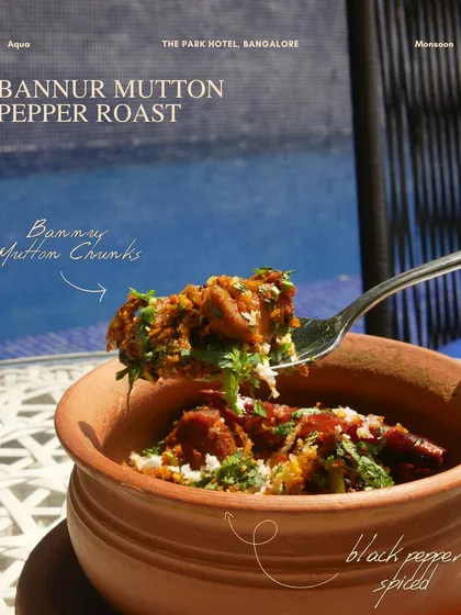 The Bannur Mutton Pepper Roast from our new menu, a spicy and flavorful dish served in a traditional clay pot, showcasing local ingredients.