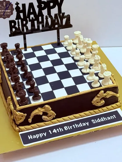 Another angle of the detailed chess theme cake, showing the intricate chocolate pieces and the elegant gold accents on the side.