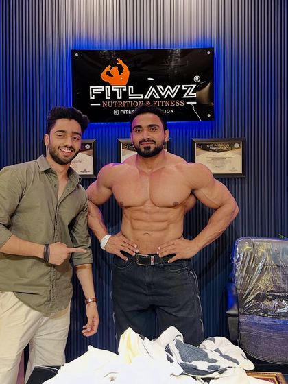 Posing with a fan at the supplement store.