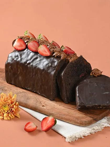 This chocolate loaf cake is dense, moist, and incredibly rich. Topped with fresh strawberries, it's a simple treat that feels utterly luxurious.