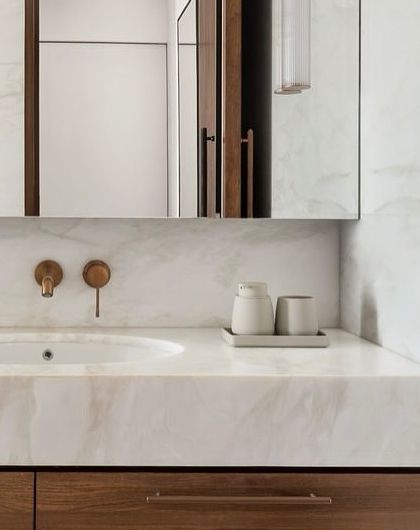 A detail shot of the vanity in the West Coast Residence, showing the clean lines of the joinery and the soft, warm tones of the onyx-like marble.