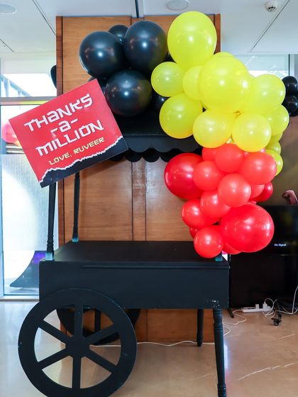 A themed cart ready for giveaways, with a sign that reads "Thanks a-million" from the birthday boy.