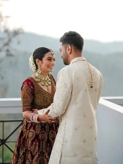 A loving gaze between the couple. Her makeup enhances her features without masking them, creating a look that is perfect for these intimate, unforgettable moments.