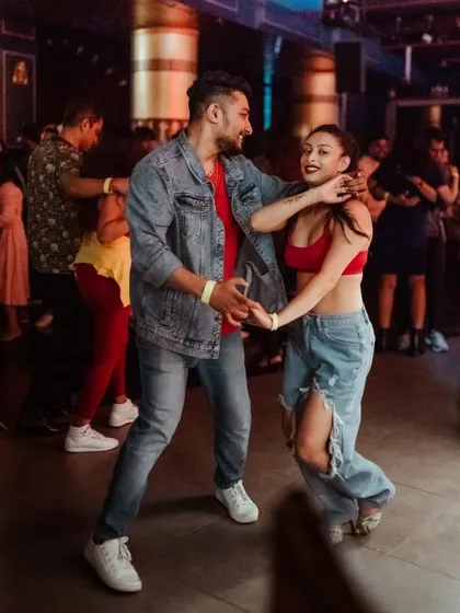 Caught in the moment during a social. This is where all the practice pays off, on a packed dance floor, just connecting with your partner and the music. This is the community we are building.
