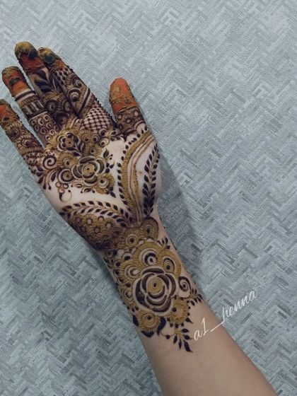 A single hand with a detailed floral and paisley design.