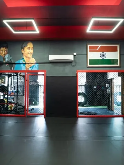 The entrance to our strength and conditioning area, framed by murals of boxing champions. We train the complete athlete here.