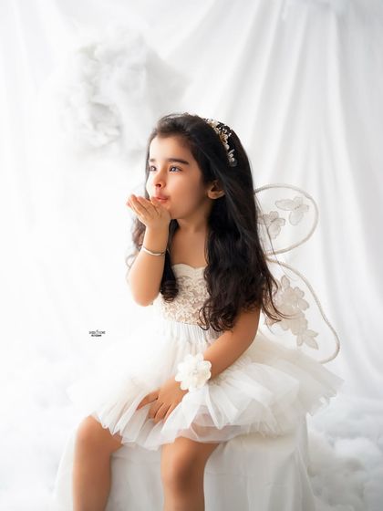 Blowing a magical kiss. This little angel is full of charm and grace.