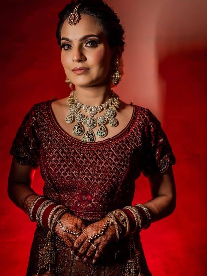 A powerful, direct look at the camera. This portrait showcases her confidence and the beautiful symmetry of her bridal makeup.