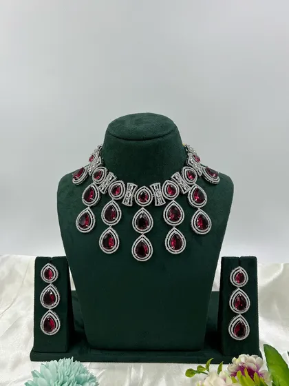 The teardrop necklace with ruby-red stones.