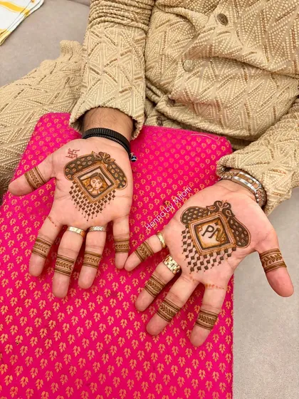 Grooms deserve special mehendi too. This is a custom design for the groom, featuring his and his partner's initials along with a fun portrait, making it a memorable part of the wedding festivities.