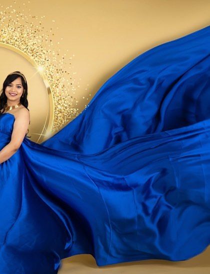 A dynamic fabric toss with a royal blue satin gown. This technique adds energy and a high-fashion feel to our studio maternity portraits.